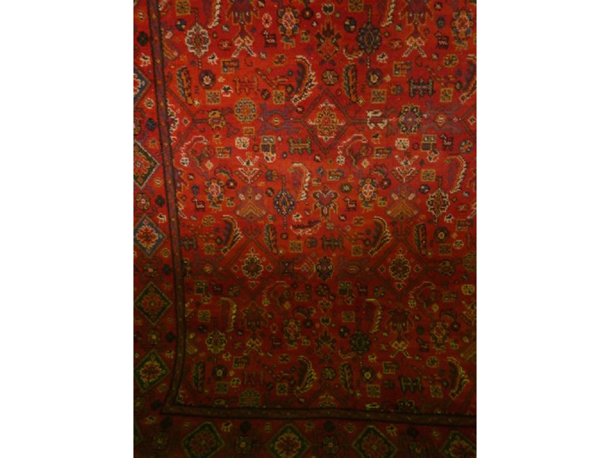 Appraisal: A rug in the Persian style with red ground field