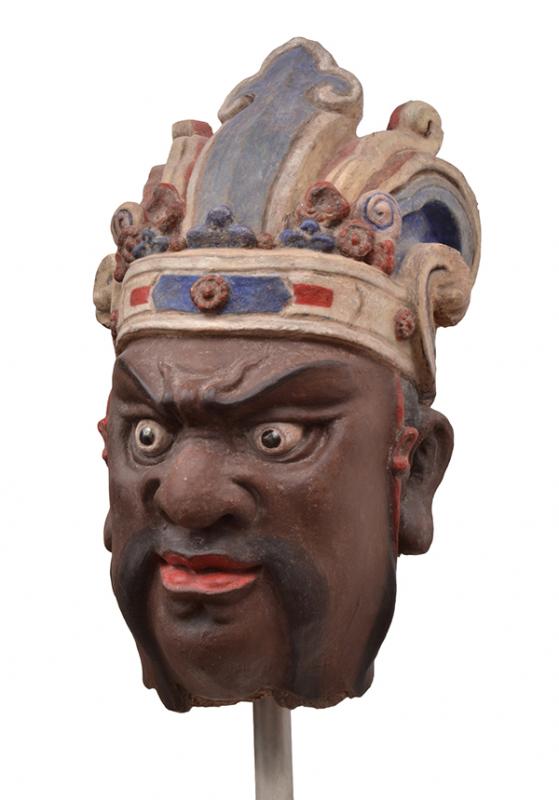 Appraisal: A CHINESE POLYCHROME STUCCO HEAD OF A GUARDIAN YUAN DYNASTY