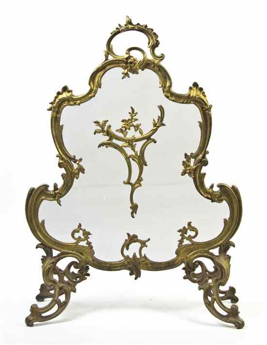 Appraisal: A Rococo Style Gilt Bronze Firescreen cast with rocaille scrolls