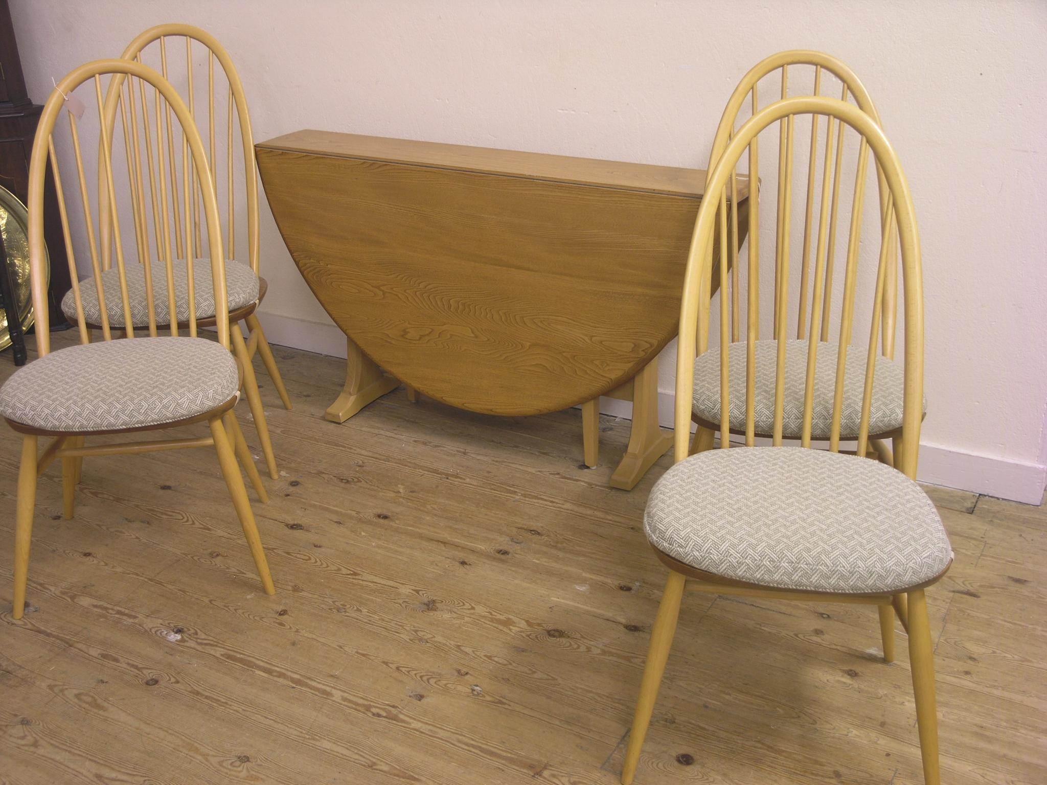 Appraisal: An Ercol light elm dining set drop-leaf table ft in