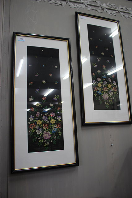 Appraisal: A PAIR OF NEEDLEWORK FLOWER PICTURES on black ground cm