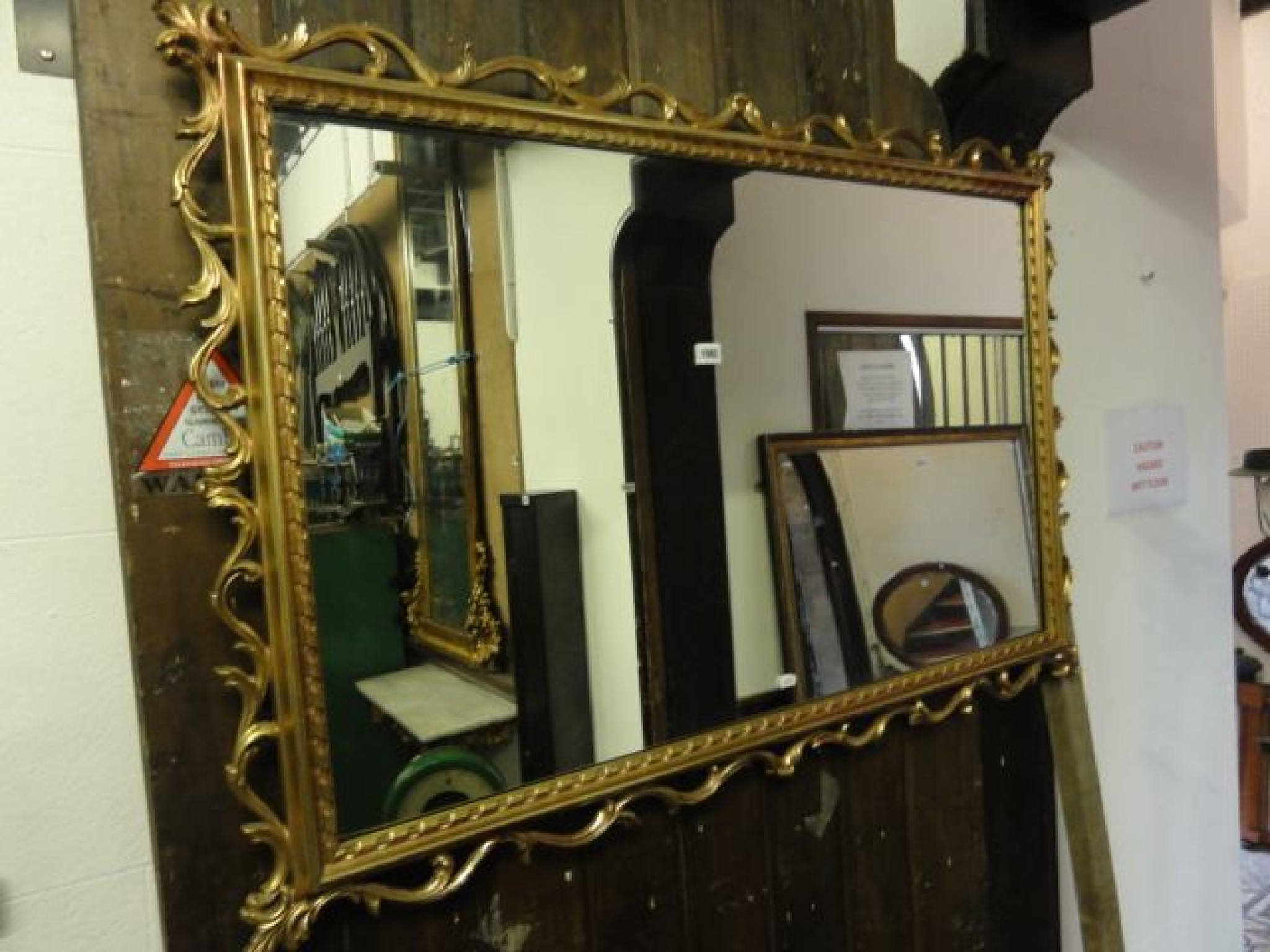 Appraisal: A contemporary gilt framed wall mirror of rectangular form with