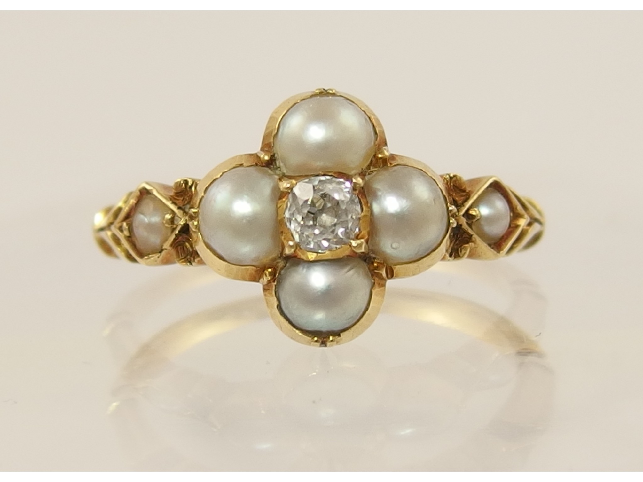 Appraisal: An Edwardian pearl and diamond ringset in unhallmarked yellow metal