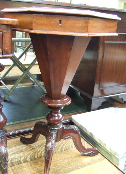 Appraisal: A Victorian walnut octagonal work box the top opening to