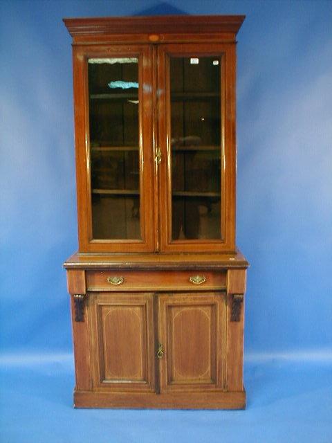 Appraisal: An Edwardian string inlaid mahogany cabinet bookcase with moulded cornice