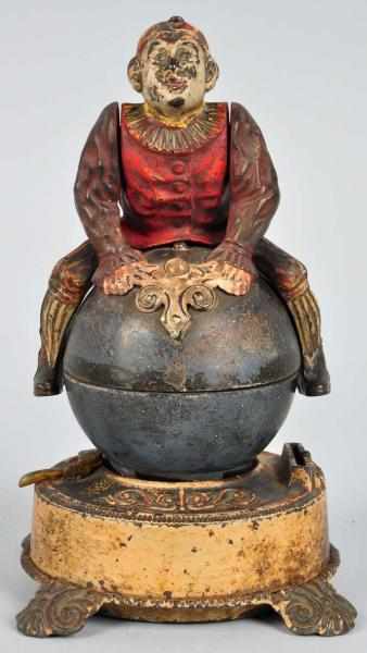 Appraisal: Cast Iron Clown on Globe Mechanical Bank Description Manufactured by