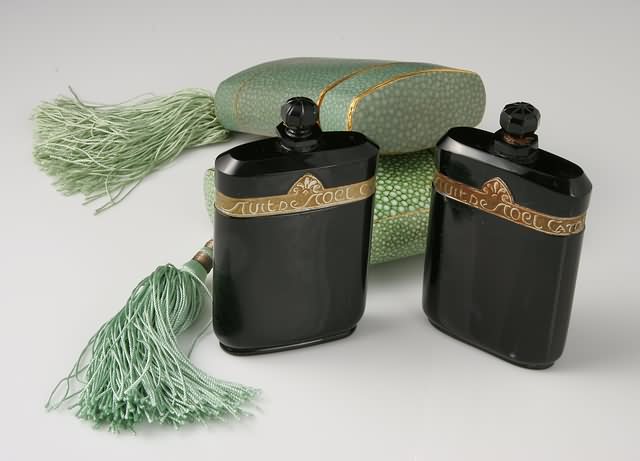 Appraisal: Black glass perfume bottles in faux shagreen cases with tassels