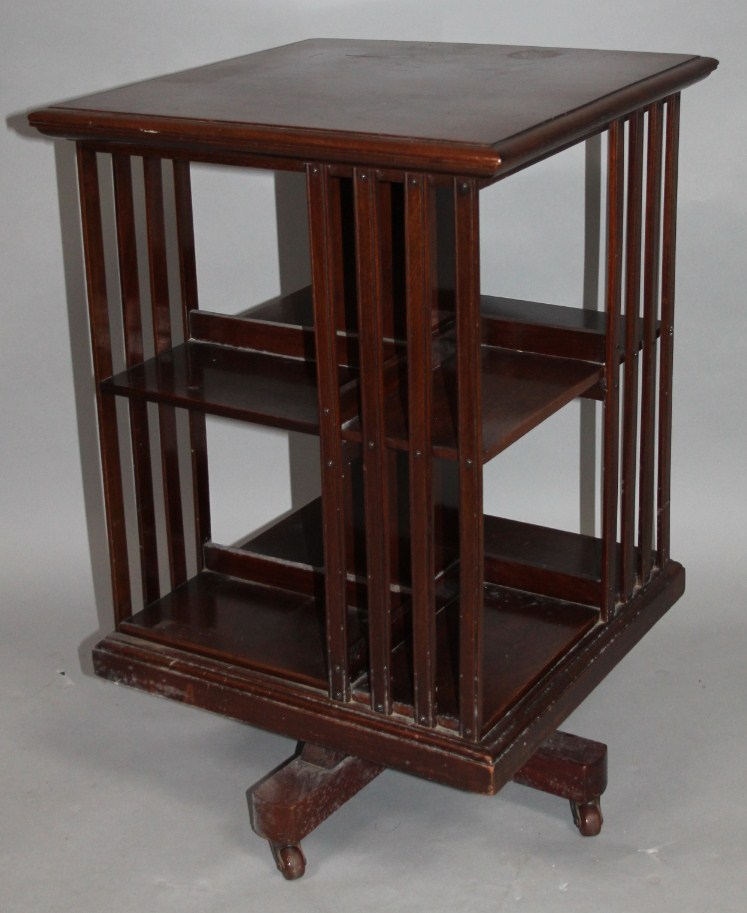 Appraisal: An Edwardian mahogany rotating bookcase of square outline with articulated