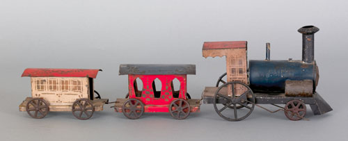 Appraisal: American tin train set late th c the engine stenciled