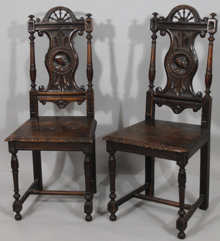 Appraisal: A pair of thC Continental elm hall chairs with carved