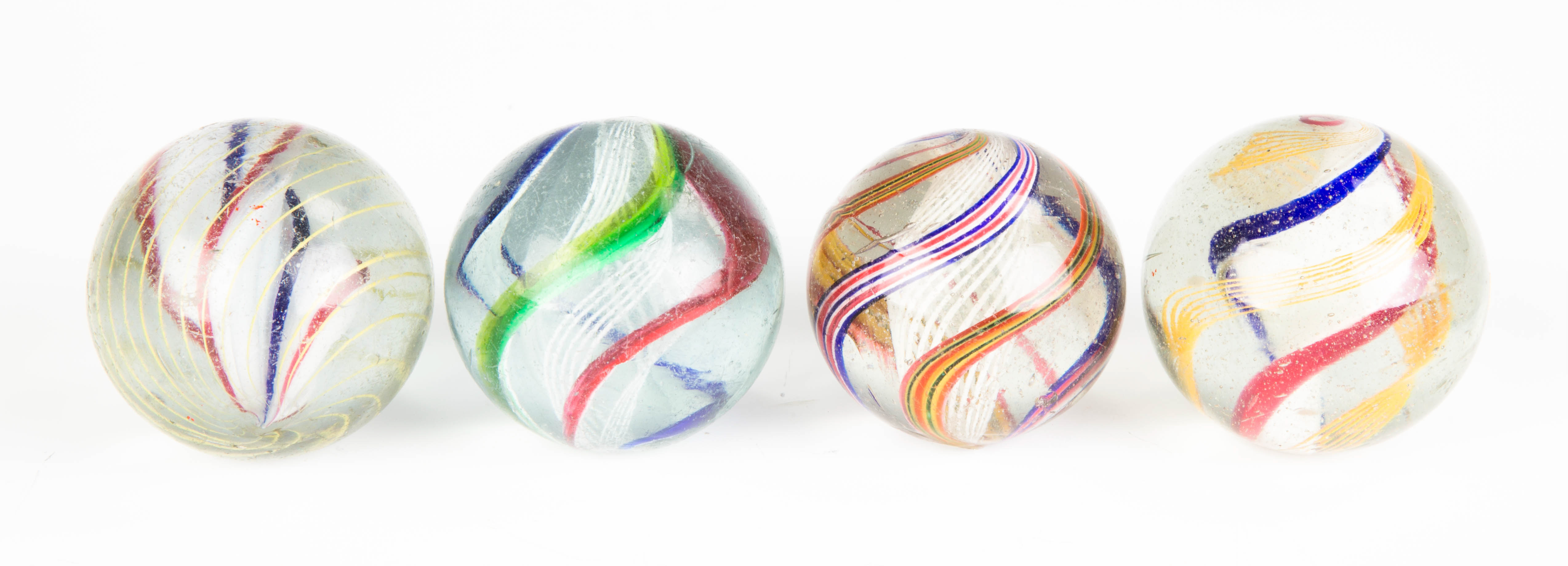 Appraisal: Four Vintage Open Core Swirl Marbles