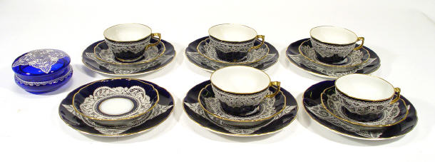 Appraisal: Five continental porcelain trios and a matching glass trinket box