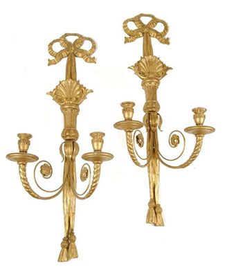 Appraisal: A pair of carved giltwood twin branch wall lights the