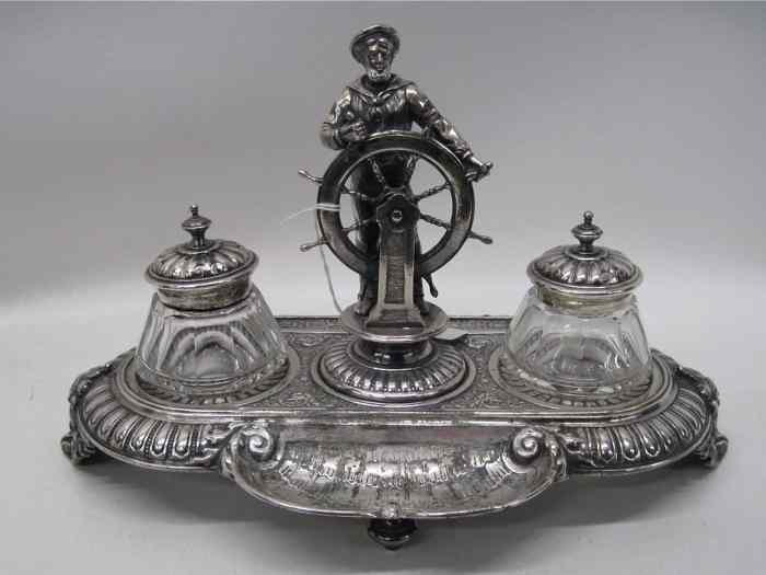 Appraisal: SILVER PLATED FIGURAL DESK SET Centered with a sailor manning