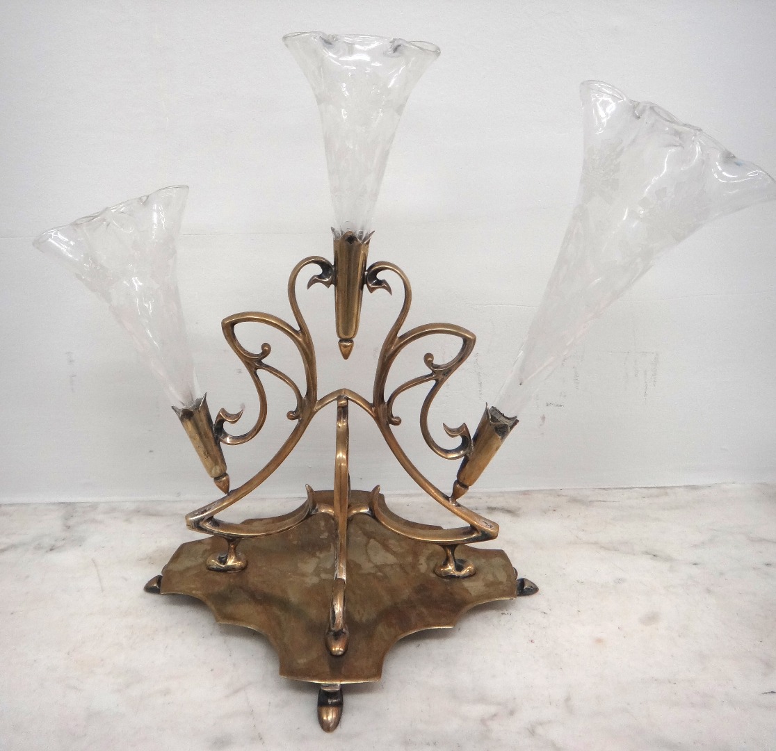 Appraisal: An Edwardian electroplate epergne of scrolling form fitted with three