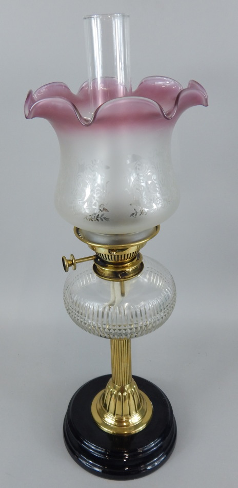 Appraisal: A Victorian oil lamp with cut glass clear reservoir brass