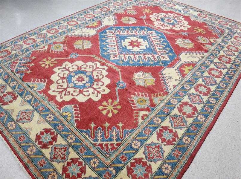 Appraisal: HAND KNOTTED ORIENTAL CARPET Pakistani Caucasian three geometric medallion design