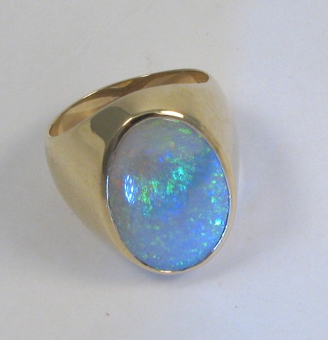 Appraisal: OPAL AND FOURTEEN KARAT GOLD RING bezel set is a