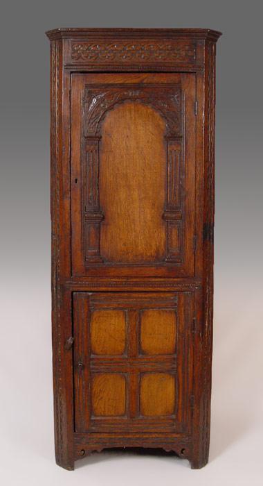 Appraisal: LARGE CARVED TH C JACOBEAN CORNER CUPBOARD Single upper arched