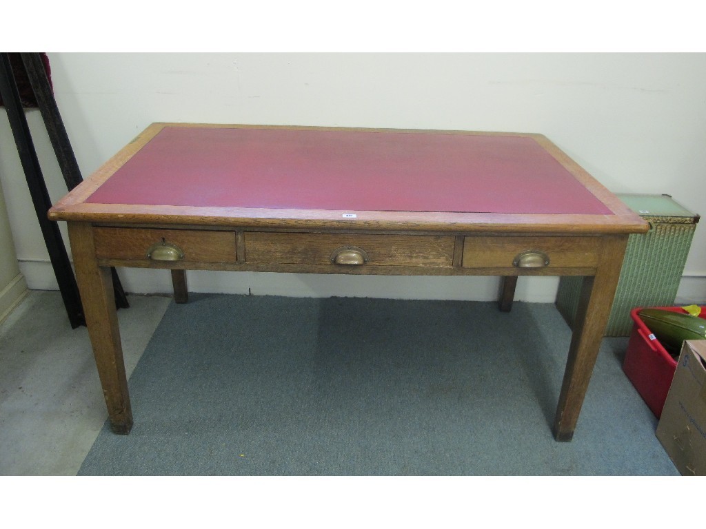 Appraisal: Oak three drawer desk with leather top