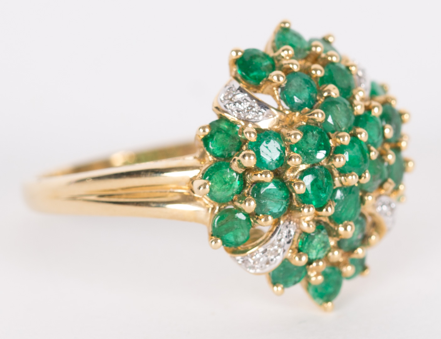 Appraisal: An Emerald Ring set in K yellow gold with cluster