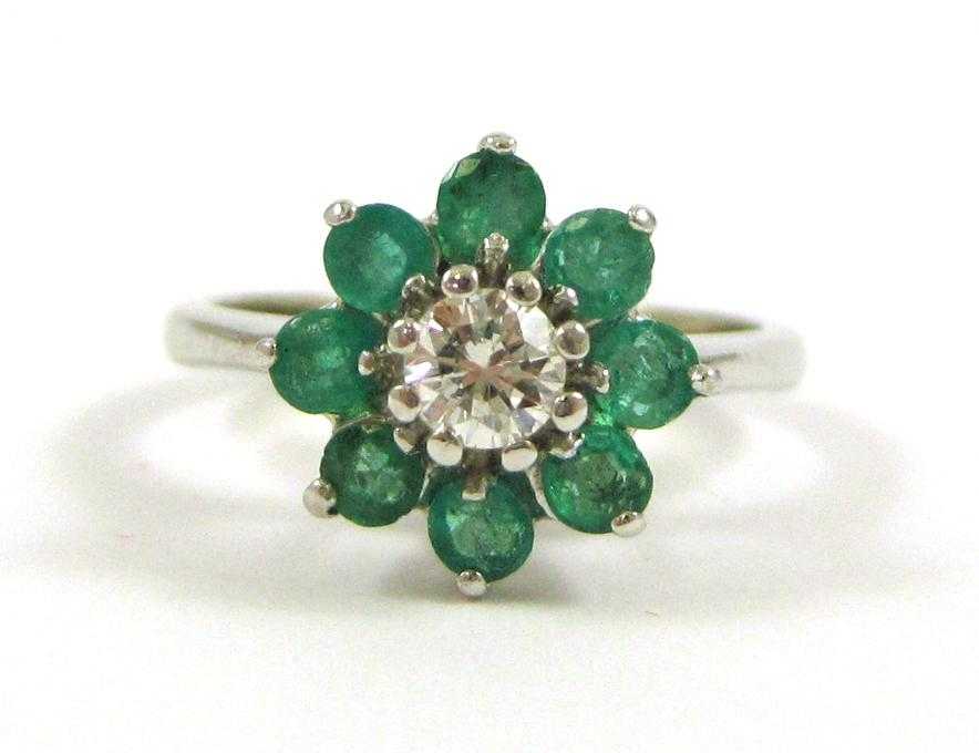 Appraisal: DIAMOND EMERALD AND FOURTEEN KARAT WHITE GOLD RING with eight