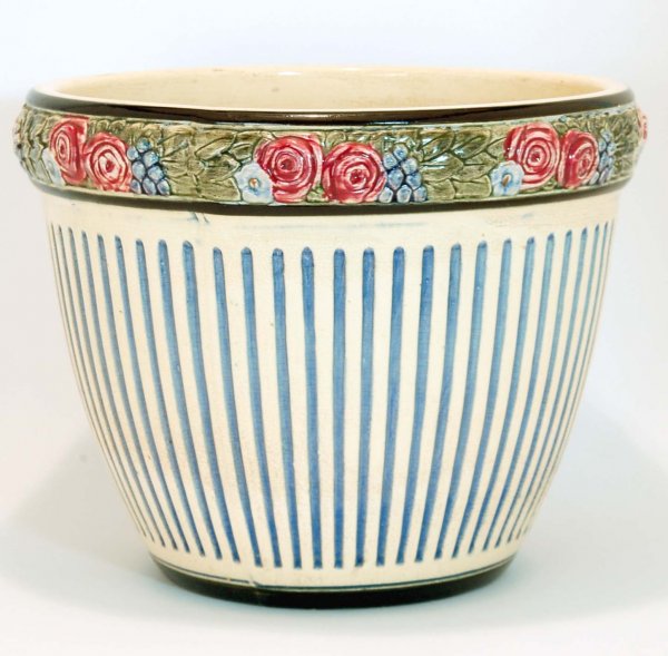 Appraisal: Weller Zona jardiniere Polychrome band of flowers over blue columns