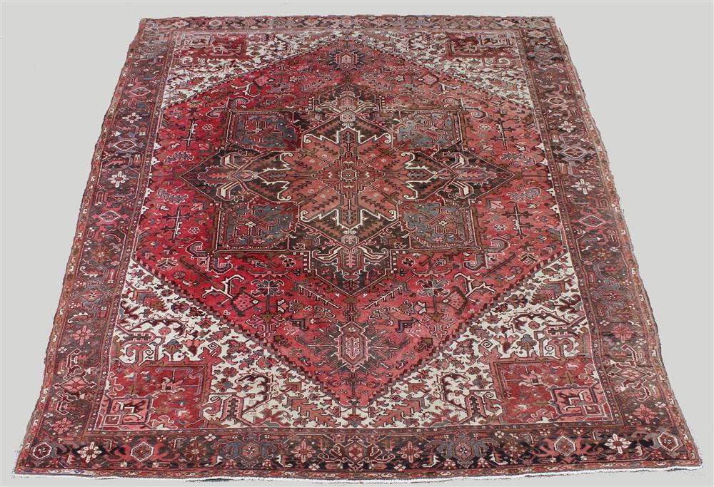 Appraisal: HERIZ WOOL RUG central medallion colors include browns reds pinks