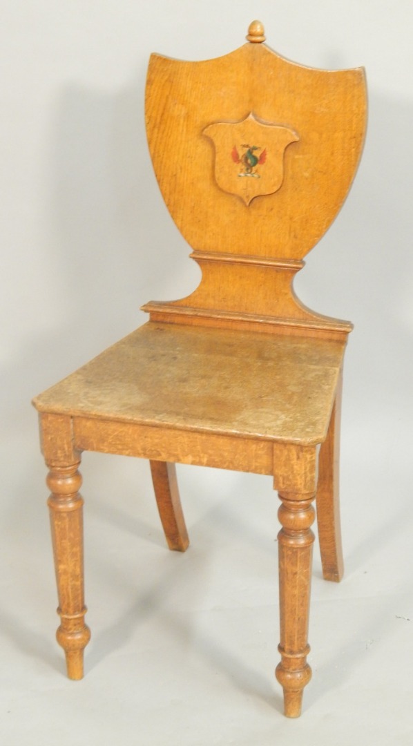 Appraisal: An early Victorian oak hall chair the shield shape back