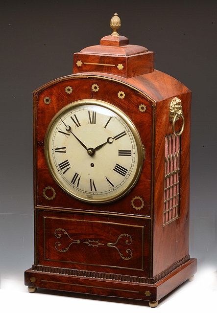 Appraisal: A REGENCY MAHOGANY LIBRARY TIMEPIECE having a white convex Roman