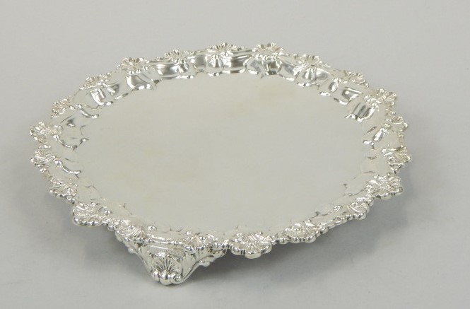 Appraisal: A Victorian silver waiter with shell and scroll border on