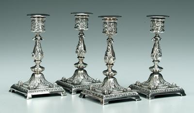 Appraisal: Four silver plated candlesticks round urn form posts square bases