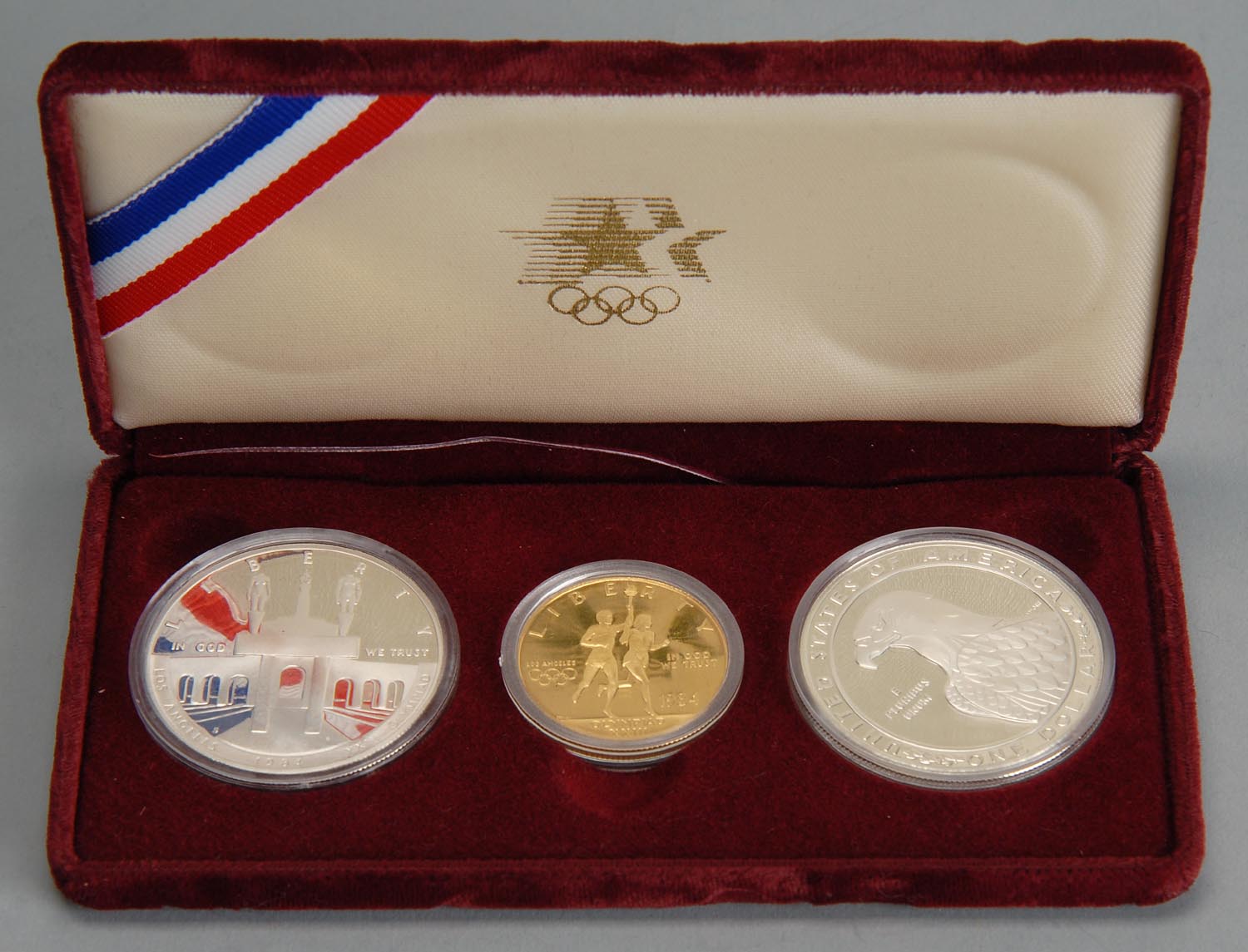 Appraisal: THREE-PIECE LOS ANGELES OLYMPICS SET consisting of two silver coins