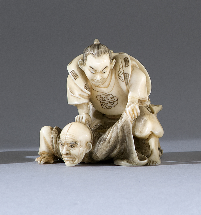 Appraisal: IVORY NETSUKE Meiji PeriodDepicting two wrestlers Signed Toshikazu Length cm