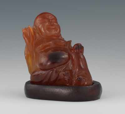 Appraisal: A Chinese Carved Agate Buddha Depicted in a seated position