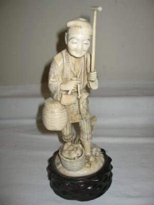 Appraisal: A CARVED IVORY OKIMONO of as a fisherman in traditional