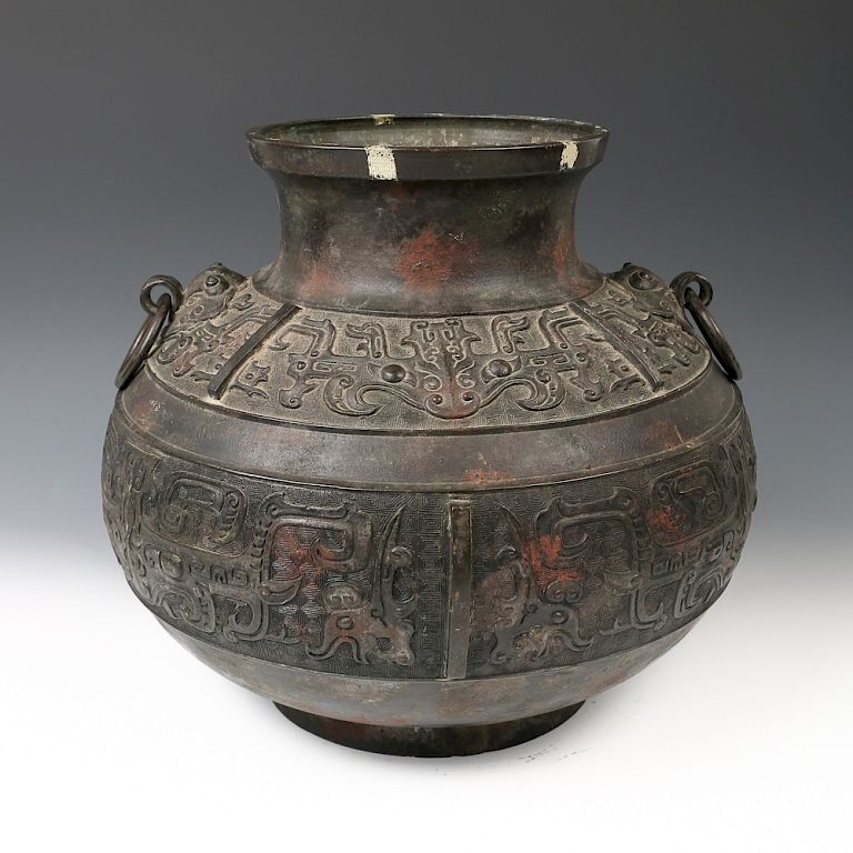 Appraisal: CHINESE ARCHAIC BRONZE DOUBLE-EAR JAR MING Of globular form supported