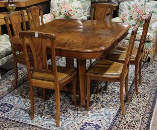 Appraisal: French Art Nouveau dining suite the bookmatched walnut top surmounting