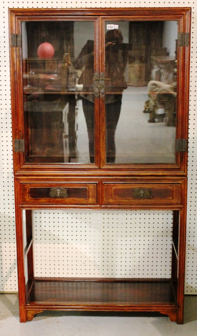 Appraisal: An early th century Chinese hardwood glazed display cabinet on