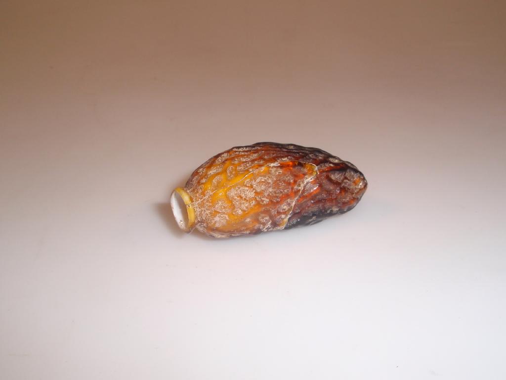 Appraisal: An amber and opaque white mould-blown glass flask in the