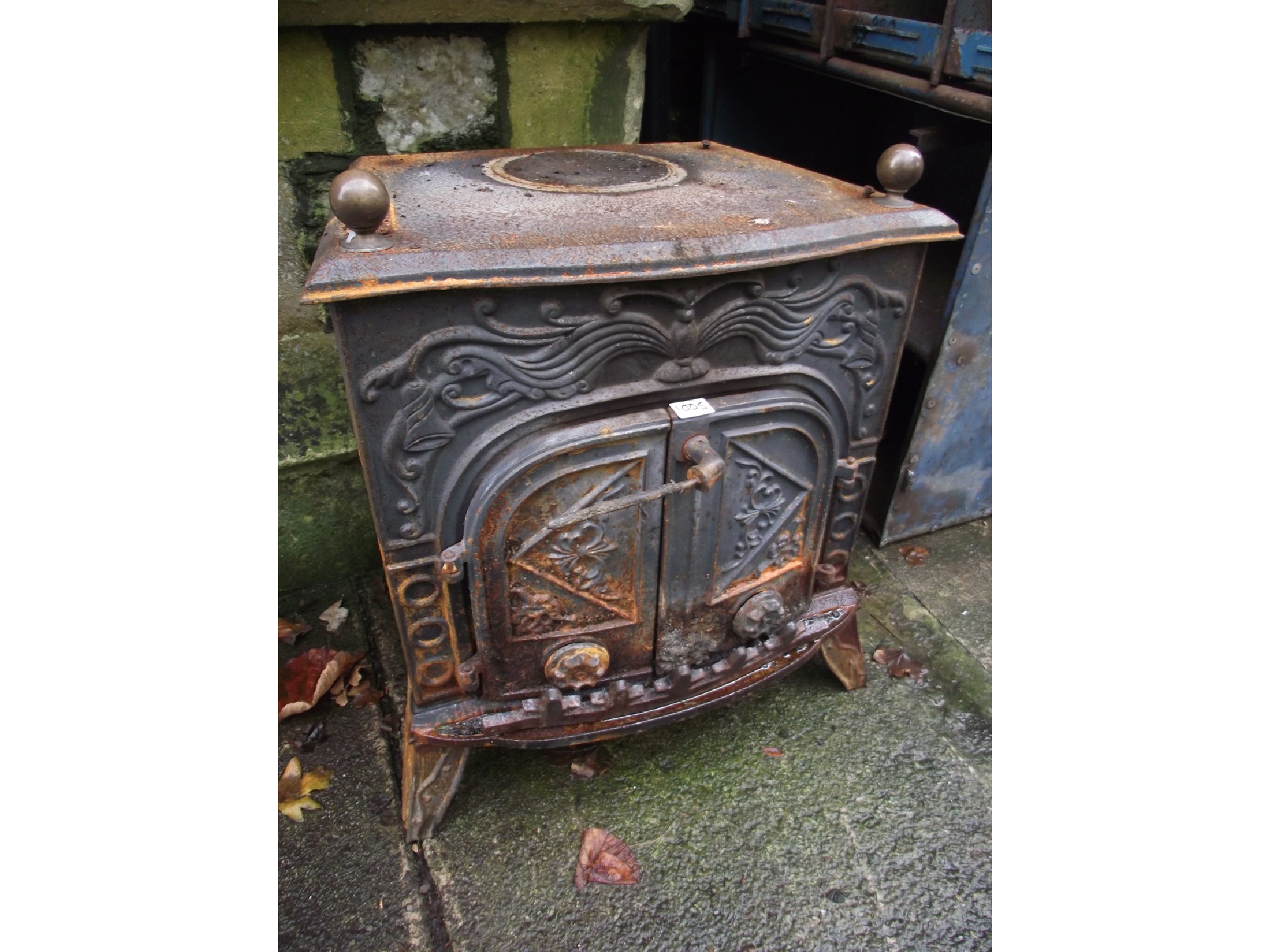 Appraisal: A cast iron wood burning stove the serpentine front with