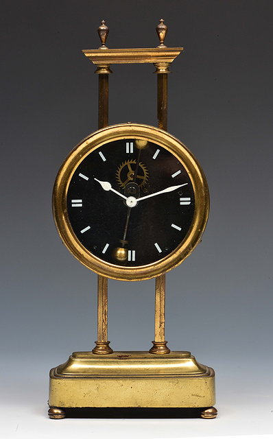 Appraisal: A brass gravity timepiecethe drum head case with glass dial