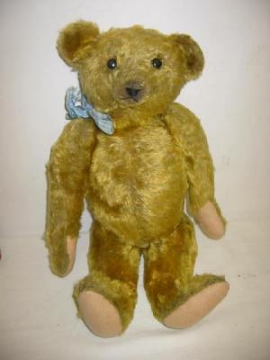 Appraisal: An English teddy bear the jointed body covered in dark