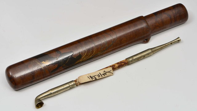 Appraisal: A JAPANESE OPIUM PIPE with engraved decoration and original label