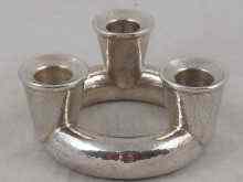 Appraisal: A white metal tests silver hammered finish triple candle holder