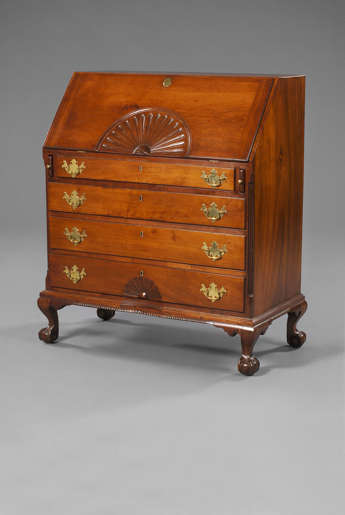 Appraisal: AMERICAN CHIPPENDALE CHERRY SLANT-LID DESK The oblong thumbmolded lid opening