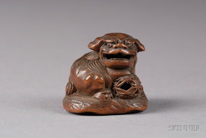 Appraisal: Hardwood Netsuke th century shishi seated on a rock with