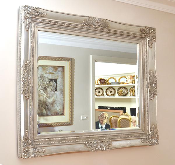 Appraisal: A RECTANGULAR BEVEL EDGED WALL MIRROR WITH A SILVERED WOODEN