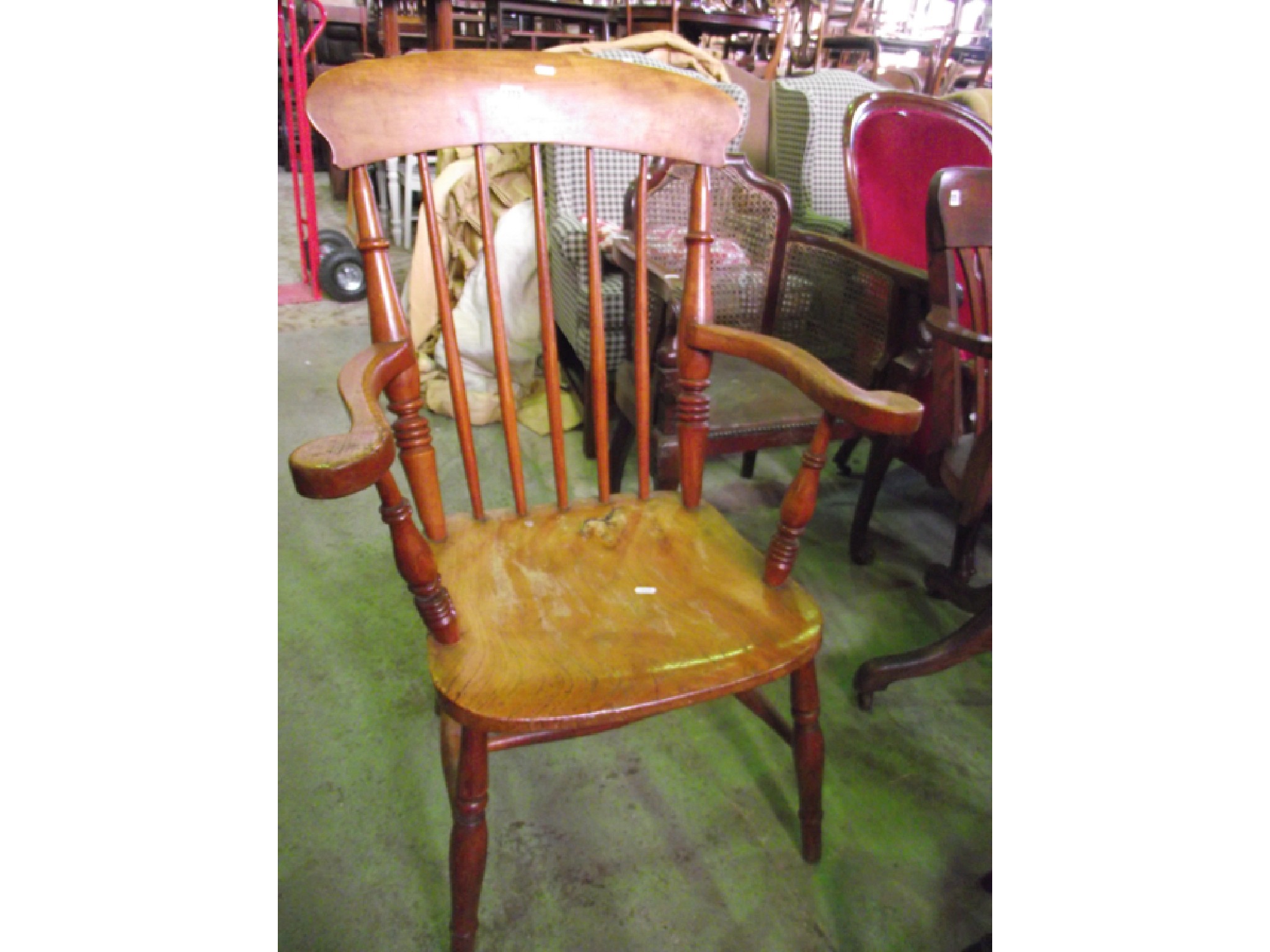 Appraisal: A Windsor stickback elbow chair with elm wood seat on