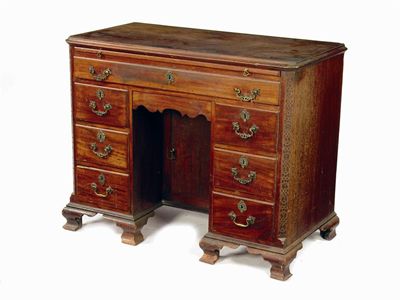 Appraisal: A George III mahogany kneehole dressing table the canted top